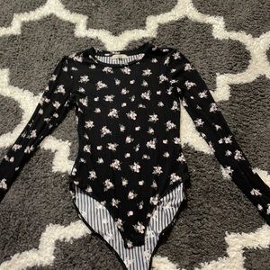 I’m selling a black bodysuit with pink flowers.